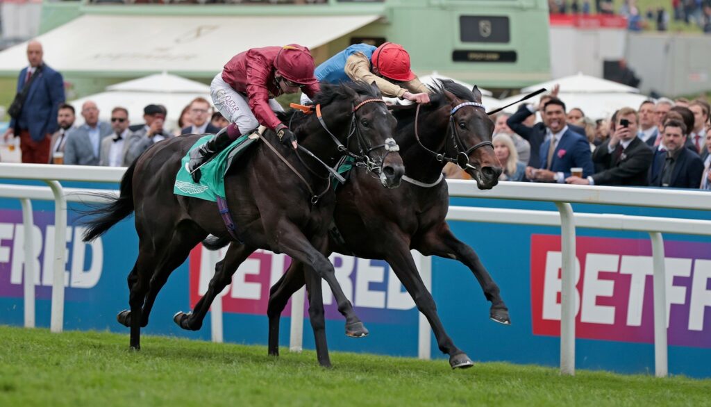 Evade winning the Listed Surrey Stakes at Epsom under Oisin Murphy.